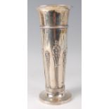 A late Victorian silver vase, of trumpet form and with leaf and flower head embossed decoration, 9.