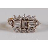 An Art Deco style 18ct gold diamond ring, arranged as eight centre baguettes within a surround of