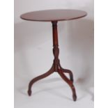 An early 19th century mahogany tilt-top pedestal tripod table, raised on turned column to umbrella