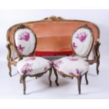 A 19th century French carved giltwood canopy, having a swept back with applied flower head carvings,