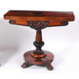 An early Victorian rosewood pedestal card table, having a fold-over top with swivel action to a