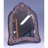 A late Victorian ebony and silver mounted easel dressing table mirror, having a shaped bevelled