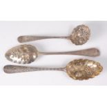 A George III silver berry spoon and one other matching example, in the Old English pattern, having