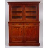 A Victorian mahogany bookcase cabinet by James Winter & Sons, the upper section having twin arched