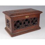 A Victorian carved oak offertory box, having hinged cover and Gothic influence flower head carvings,