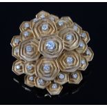An 18 carat gold and diamond set brooch by Boucheron, the raised and shaped panels of stepped