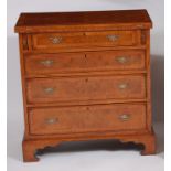 An early Georgian style figured walnut, oak crossbanded and further inlaid bachelors chest, the