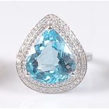 A white gold, blue topaz and diamond pear shaped cluster ring, comprising a centre pear cut blue