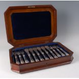 A mid-Victorian silver twelve place setting of fish knives and forks, in fitted walnut and burr