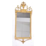 A late 18th century giltwood and gesso wall mirror, having a central urn and entwined foliate