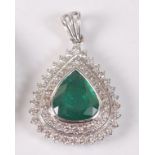 A white metal, emerald and diamond pear shaped cluster pendant, featuring a centre pear cut