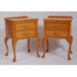 A pair of 1920s satin birch two drawer bedside tables by Waring & Gillows, each with ledgebacks,