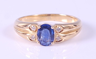 A yellow metal, sapphire and diamond dress ring, comprising an oval faceted sapphire in a four