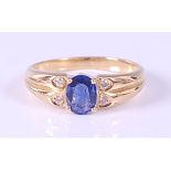 A yellow metal, sapphire and diamond dress ring, comprising an oval faceted sapphire in a four