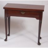 A mid-18th century mahogany fold-over tea table, having single rear gateleg action, single long