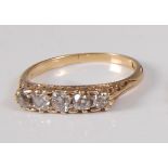 An early 20th century yellow metal five stone diamond half hoop ring, featuring five graduated Old