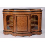 A Victorian figured walnut shaped front credenza, having a central marquetry inlaid and bowed