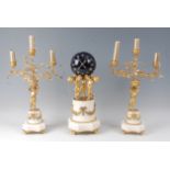 A 19th century French gilt bronze and white marble clock garniture, the clock modelled as three