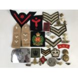 Sundry military badges and insignia including a Scottish dress buckle