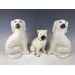 A pair of Staffordshire dogs together with a pug dog