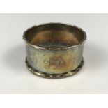 A silver napkin ring engraved with the initials P.D.