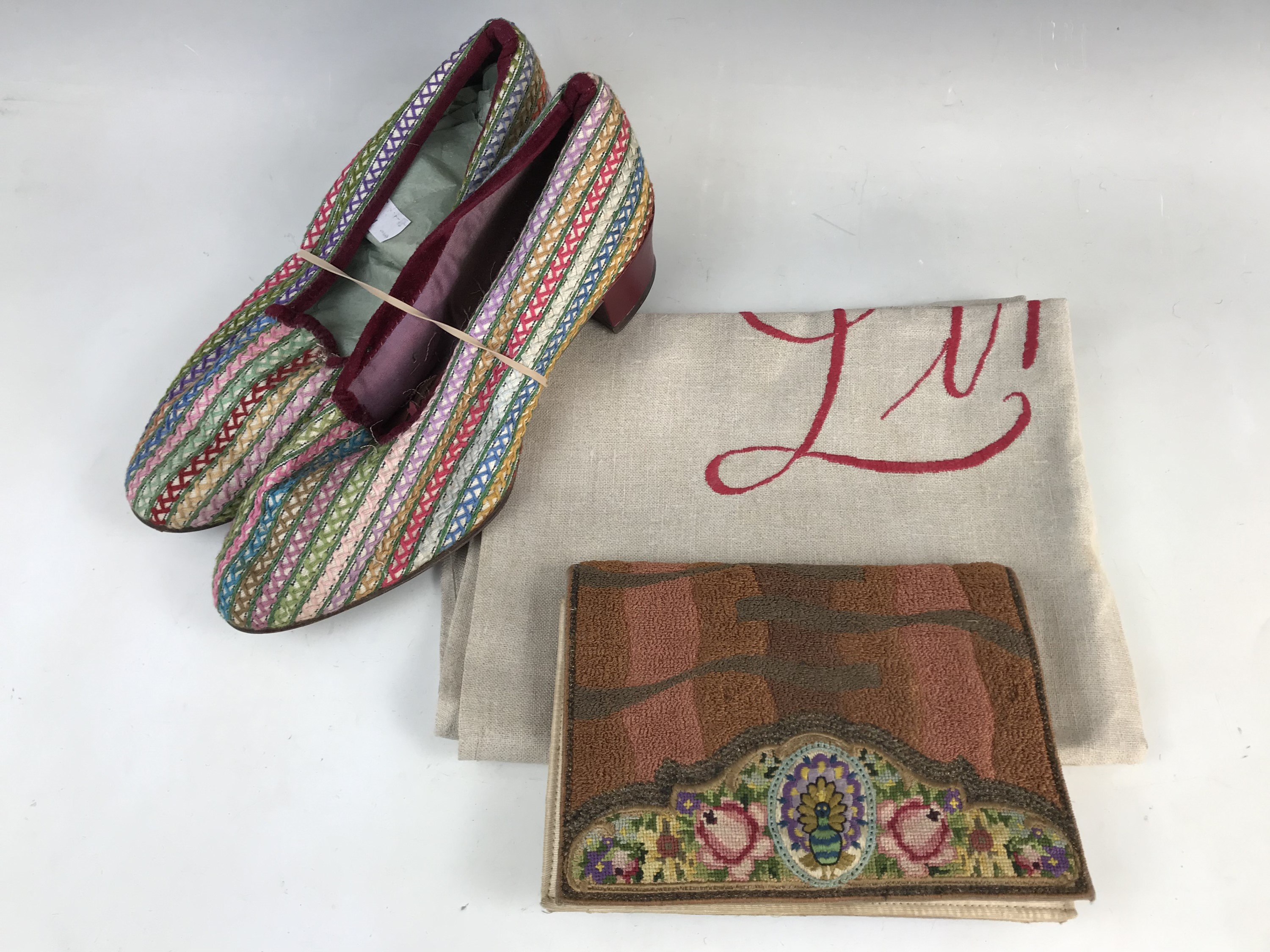 A 1940s lady's pair of embroidered shoes, decorated with bands of running stitch worked in