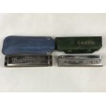 Cased Bandmaster and Hohner Echo harmonicas