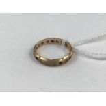 A yellow-metal eternity ring set with paste stones, stamped 9ct, tests as gold, 2g (a/f)