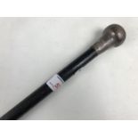 A silver handled walking cane