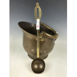 A brass coal helmet together with a brass ladle