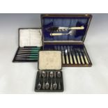 A cased set of electroplate fish servers together with a set of fish eaters, cased tea knives and