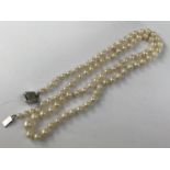 A vintage single-strand necklace of graded pearls, on a white-metal box-link clasp, stamped '