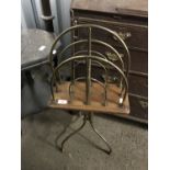 An Edwardian oak and brass floor standing magazine rack