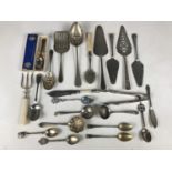 Sundry electroplate cutlery including two sugar tongs, a boxed King George VI coronation spoon and