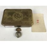 A Princess Mary Christmas 1914 gift tin together with card and a cap badge