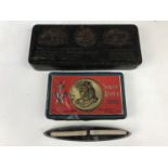 A Boer War gift to the troops chocolate tin, two 1914 Princess Mary gift tin cigarettes, and a "Gift