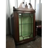 A reproduction Glenister wall mounted glazed corner cabinet