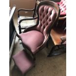 A contemporary mahogany button back nursing chair with conforming footstool