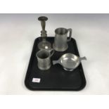 An early 19th century pewter candlestick together with two pewter tankards and a presentation