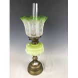 A brass and vaseline glass oil lamp, 63 cm