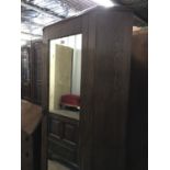 An early 20th century oak and pine corner wardrobe