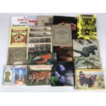 A quantity of tea and cigarette card albums and contents, postcards etc