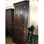 A George III oak floor-standing corner cabinet