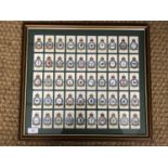 A framed display of Players cigarette cards depicting RAF squadron badges