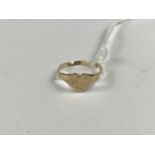 A child's yellow-metal signet ring, having a heart-shaped face, stamped 9ct, .67g