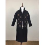 An early 1960s black knitted wool wiggle suit by Tricoville, comprising button-fronted jacket and