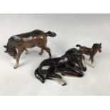 A Beswick foal together with two others