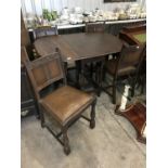A 1940s oak drop leaf table and four chairs