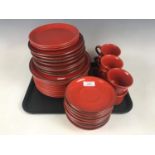 A quantity of red stoneware tea ware, pattern number 00563