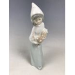 A Lladro figurine of a girl with a cockerel